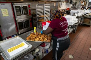 woman packing food in to-go containers
